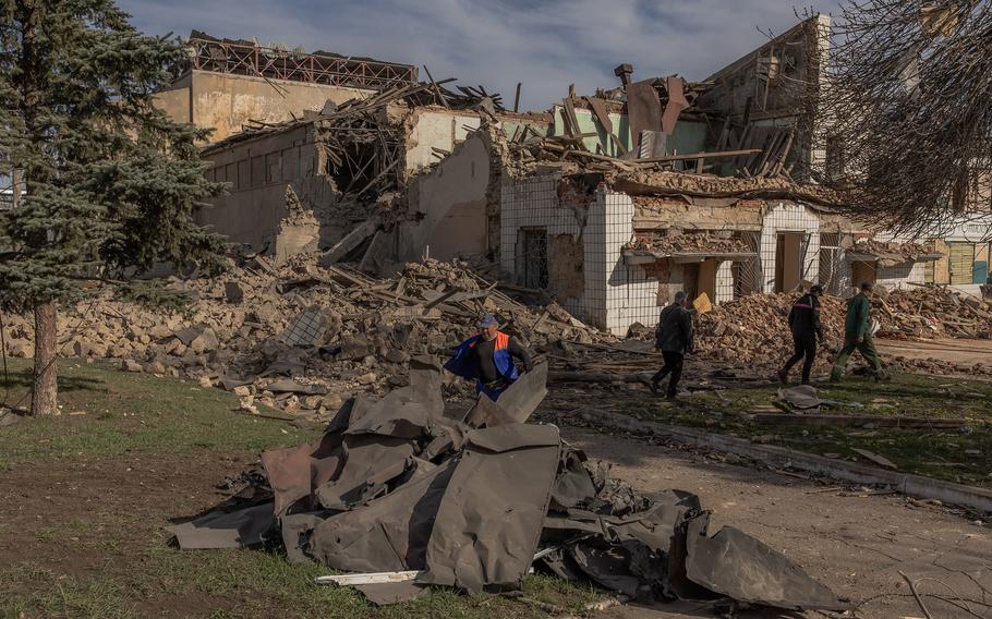 Communal workers clear rubble following an overnight missile strike on a House of Culture in the town of Druzhkivka, Donetsk region, on Monday, April 1, 2024, amid the Russian invasion of Ukraine.