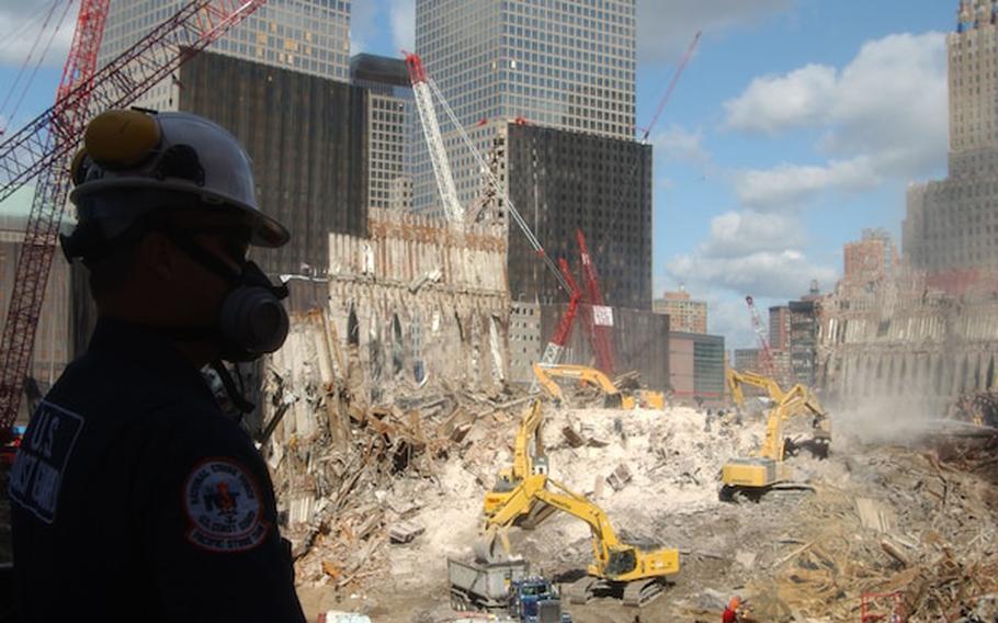 Petty Officer Ray Brown from the Coast Guard Pacific Strike Team looks out at Ground Zero in New York City on Sept. 17, 2001. The Coast Guard along with the EPA is monitoring personnel and air safety concerns at Ground Zero. 