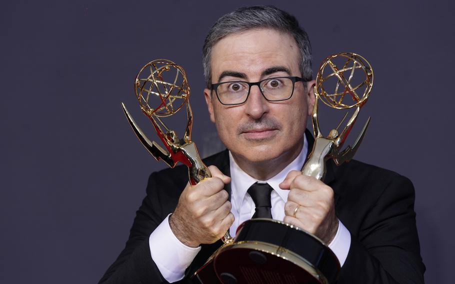 John Oliver poses for a photo with the awards for outstanding writing for a variety series and outstanding variety talk series for “Last Week Tonight with John Oliver” at the 73rd Primetime Emmy Awards on Sunday, Sept. 19, 2021, at L.A. Live in Los Angeles. 