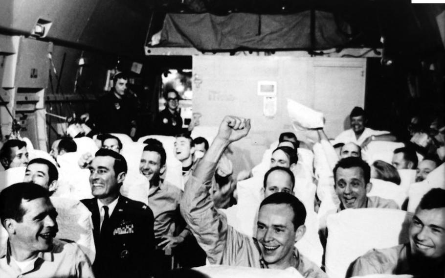 Returning prisoners of war cheer as a U.S. Air Force C-141 Starlifter takes off from Gia Lam Airport, Hanoi, for the flight to Clark Air Base in the Philippines in February 1973. 