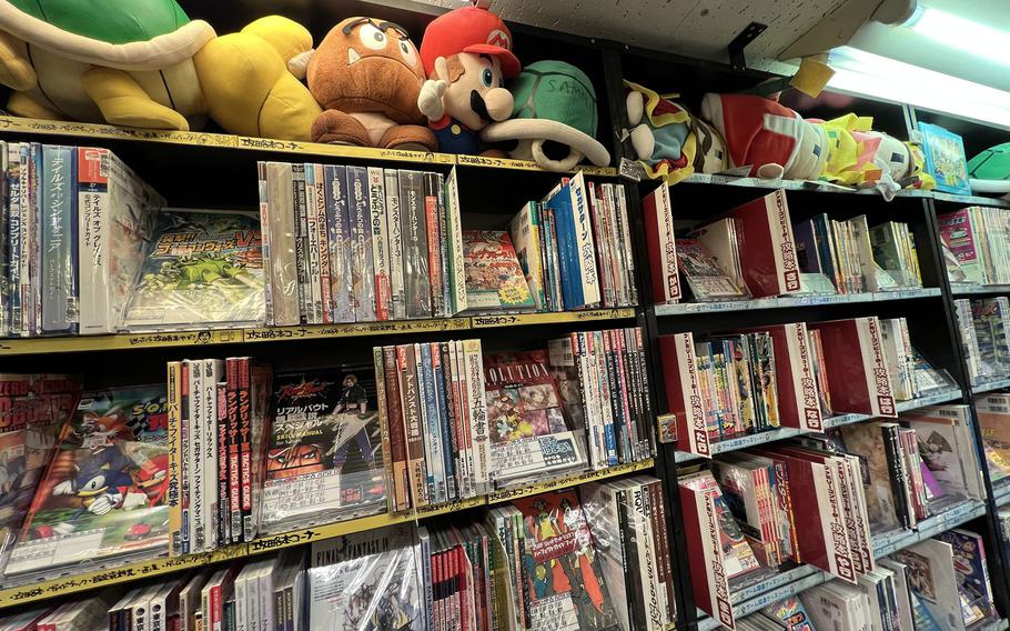 Books and Super Mario toys fill the shelves at Super Potato, a haven for fans of retro video games, in Akihabara, Tokyo, Nov. 30, 2021.