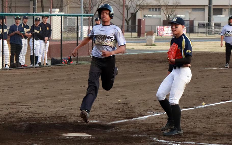 Zama‘s David King crosses home plate against St. Mary’s during Tuesday’s Kanto Plain baseball game. The Trojans won 9-5, their eighth straight win, making them 9-1 on the season.