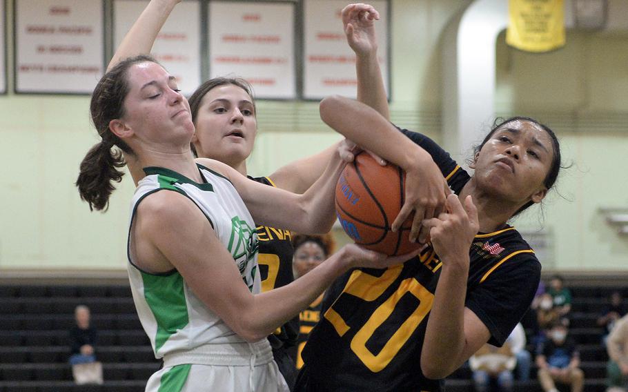 Gimme that ball! Kubasaki's Adria Lockhart and Kadena's Ayanna Levi tussle for the ball during Thursday's Okinawa girls basketball game. The Panthers won 36-19.