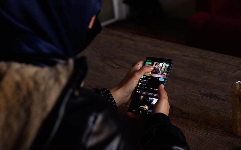 A young woman working for an Afghan YouTube channel edits content in its office in Kabul.