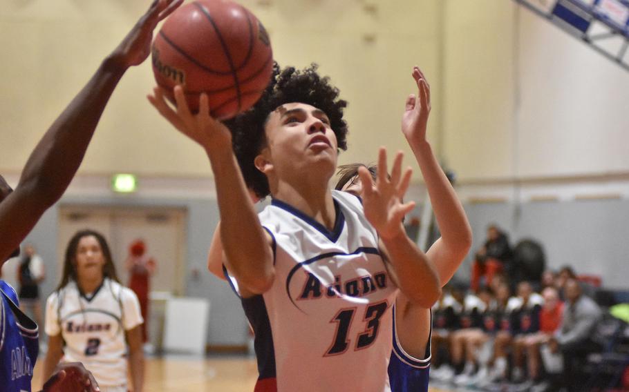 Aviano's Malakai Harkley manages to just get a shot off near the basket on Friday, Dec. 9, 2022, in the Saints' 51-40 victory over Rota in Aviano, Italy.