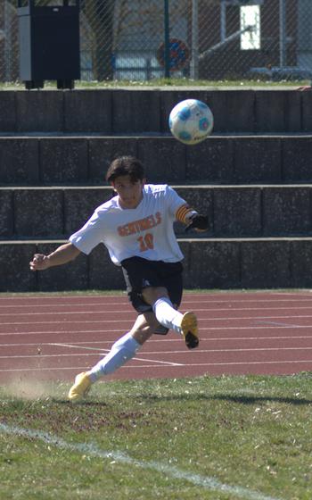 Troy Truscott kicks a corner.