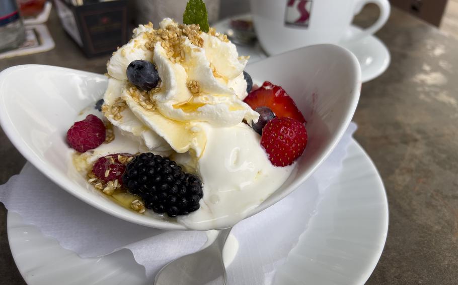 Tje frozen yogurt parfait at Zum Landgrafen restaurant in Ludwigswinkel, Germany, is topped with blackberries, strawberries, blueberries, warm honey and sesame seeds.