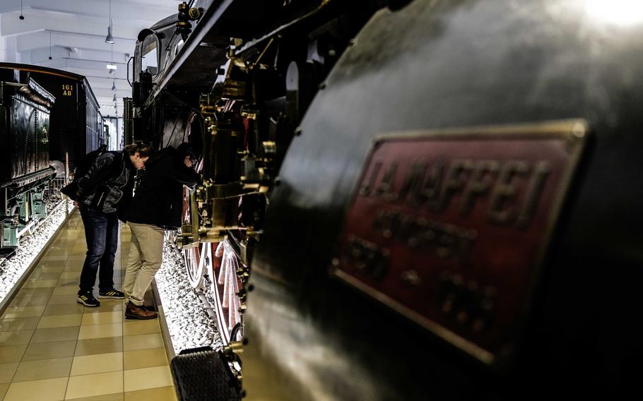 Visitors explore a wheel mechanism on the Fast Train Locomotive S 2/6 of the Royal Bavarian State Railway at the German Railway Museum in Nuremberg, Germany, Dec. 20, 2023. The steam locomotive was built in 1906 and was once the fastest train in Germany.