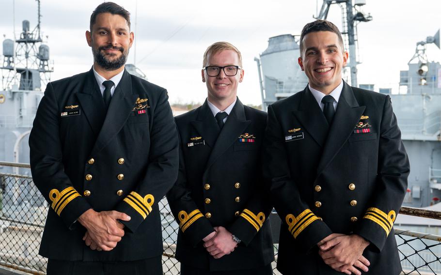 Royal Australian navy Lt. Cmdr. Adam Klyne, left, Lt. William Hall, center, and Lt. Cmdr. James Heydon pose aboard the USS Yorktown in Mount Pleasant, South Carolina, Jan. 12, 2024.