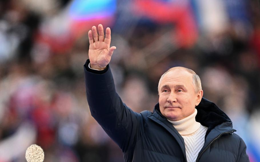 Russian President Vladimir Putin greets people gathered to attend the concert marking the eighth anniversary of the referendum on the state status of Crimea and Sevastopol and its reunification with Russia, in Moscow, Russia, Friday, March 18, 2022. 