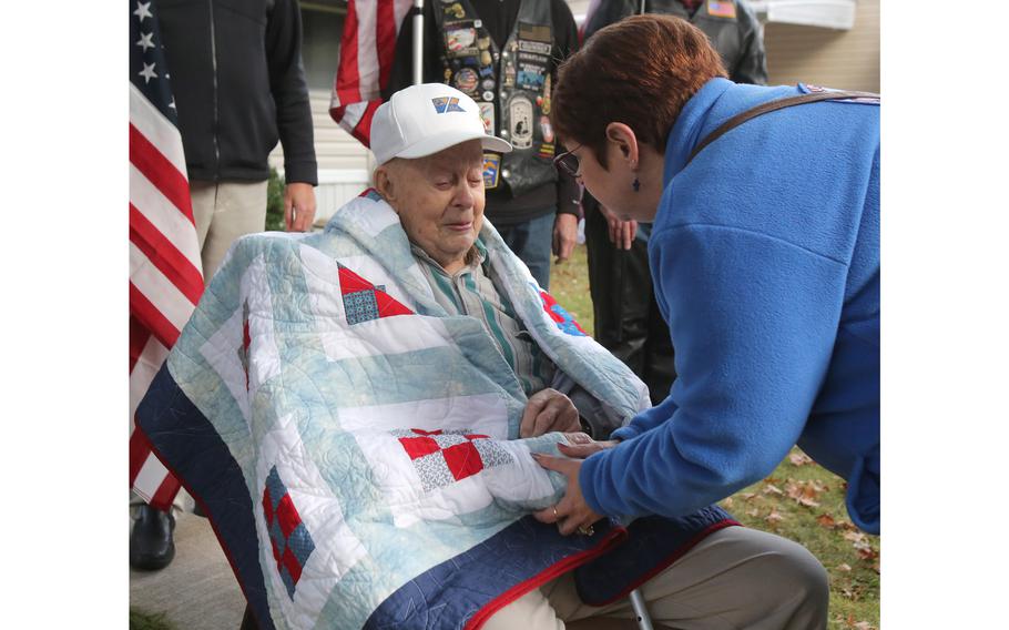 Brenda Russell, president of Blue Star Mothers, wishes a happy birthday to WWII veteran Denver Conard. Conard became emotional when he wished his wife could have been there for the presentation of his Quilt of Valor. She died nearly two years ago.
