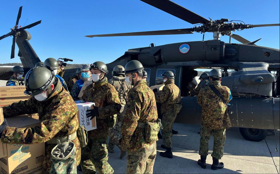 Japanese soldiers unload earthquake aid from a U.S. Army UH-60 Black Hawk helicopter at Noto Airport in Ishikawa prefecture, Japan, Jan. 17, 2024. 