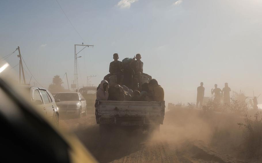 Displaced Palestinian families from the northern and central Gaza Strip evacuate toward southern Gaza on Friday, Oct. 13, 2023.