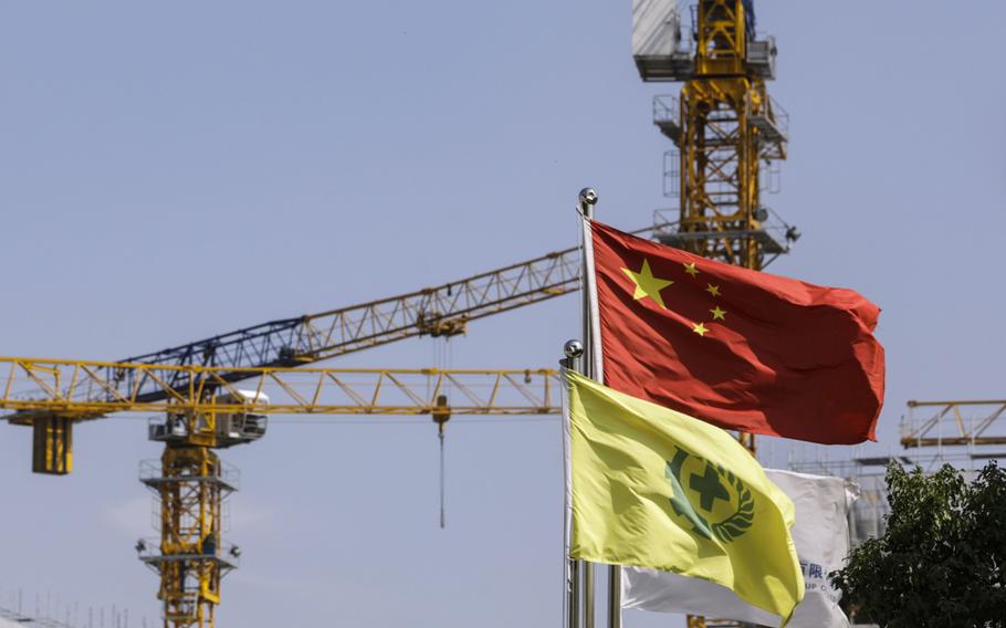 A Chinese flag is flown near a construction site for residential buildings in the Fengxian district of Shanghai on Oct. 17, 2020. 