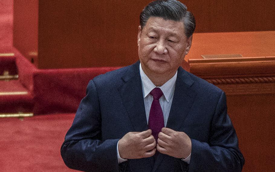 Chinese President Xi Jinping adjusts his jacket during a ceremony at the Great Hall of the People on April 8, 2022, in Beijing. 