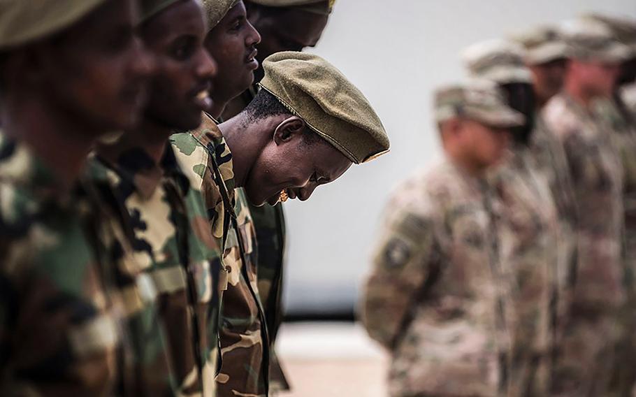 36p na                    In an August, 2018 photo, Somali national army soldiers stand in formation, waiting to receive certificates of completion at a logistics course graduation ceremony. Soldiers from Somalia's advanced infantry Danab battalion spent 14 weeks training with the U.S. 10th Mountain division on the importance of logistical operation as well as the operation and maintenance of heavy equipment.
EVAN PARKER/DOD