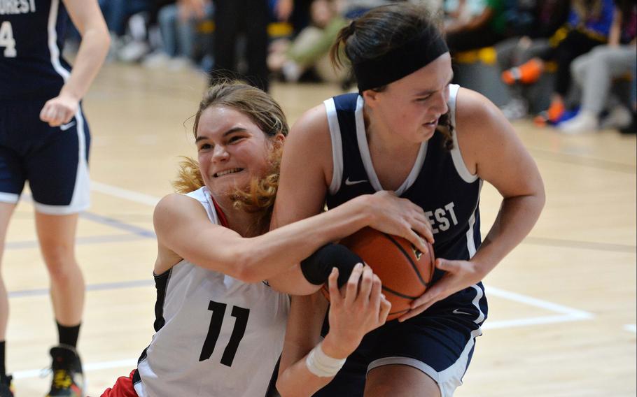 AOSR’s Natalia DiMatteo fights for the ball with Black Forest Academy’s Olivia Kruse in a Division II semifinal at the DODEA-Europe basketball championships in Ramstein, Germany, Feb. 17, 2023. AOSR beat BFA 34-31 to advance to the championship game against Naples.