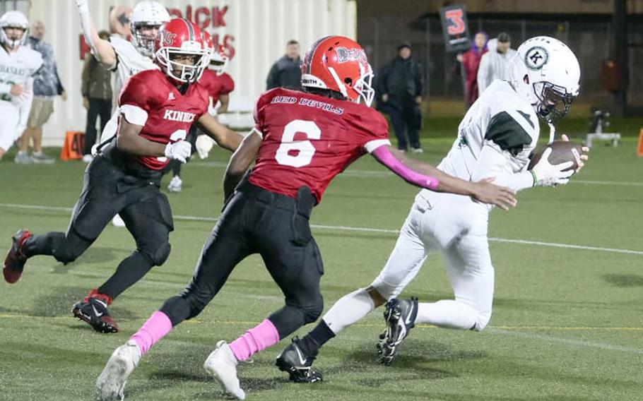 Kubasaki's Caleb Stephan pulls in an interception in the closing seconds in front of Nile C. Kinnick's Trey Bennett and Wendell Harrison.