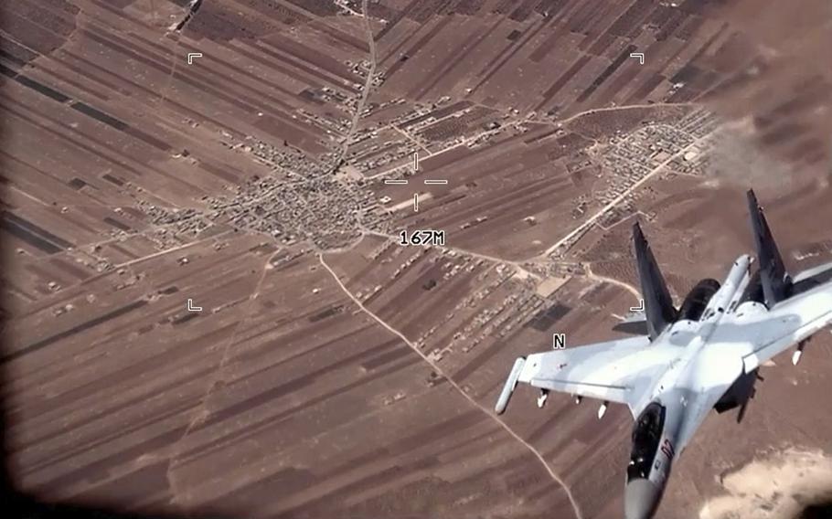 In this image from video released by the U.S. Air Force, a Russian SU-35 flies near a U.S. Air Force MQ-9 Reaper drone on Wednesday, July 5, 2023, over Syria. The U.S. Air Force says Russian fighter jets flew dangerously close to several U.S. drone aircraft over Syria, setting off flares and forcing the MQ-9 Reapers to take evasive maneuvers.