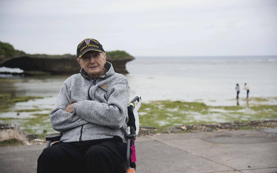 A Marine Corps veteran sits in a wheelchair at the beach. 