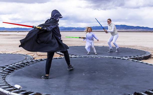 People battle with light sabers on trampolines at OutpostX in Beryl, Utah. 