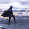 People battle with light sabers on trampolines at OutpostX in Beryl, Utah. 