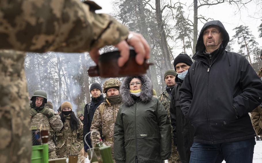 Volunteers and veterans of the Ukrainian Territorial Defense Forces get a briefing on various types of mines on Feb. 5, 2022, on the outskirts of Kyiv.
