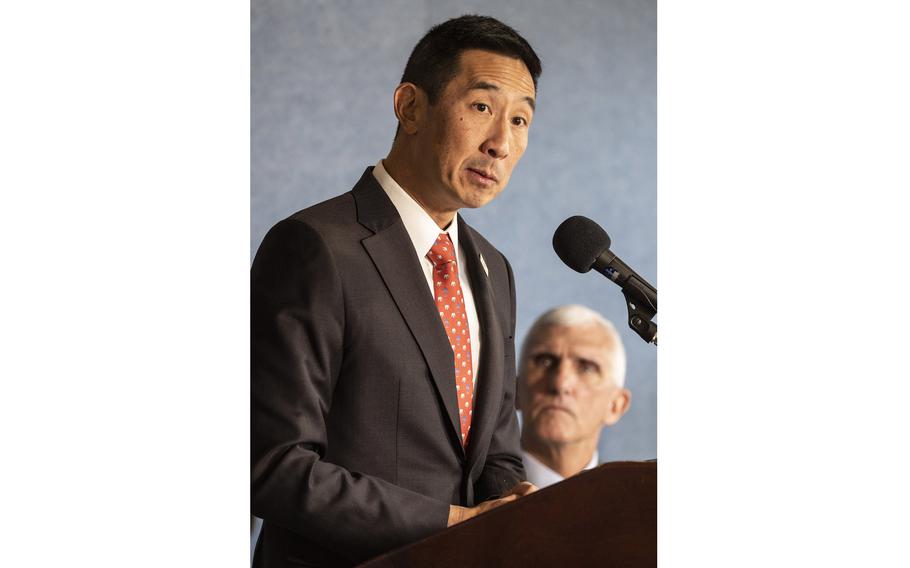 Charles K. Djou, secretary of the American Battle Monuments Commission, speaks at a news conference on Wednesday, Dec. 14, 2022, at the National Press Club in Washington, D.C. In the background is retired Army Lt. Gen. Mark P. Hertling, chairman of the commission.