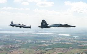 A T-6 Texan II and a T-38C Talon with the 12th Flying Training Wing fly in formation during The Great Texas Airshow in April 2022, at Joint Base San Antonio-Randolph, Texas. The Air Force has grounded 279 of the trainer airplanes due to concerns about potentially faulty ejection seat parts.
