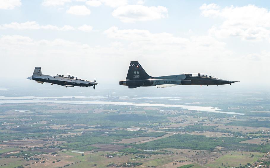 A T-6 Texan II and a T-38C Talon with the 12th Flying Training Wing fly in formation during The Great Texas Airshow in April 2022, at Joint Base San Antonio-Randolph, Texas. The Air Force has grounded 279 trainer airplanes due to concerns about potentially faulty ejection seat parts.