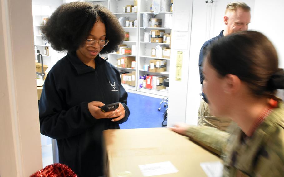 Senior Airman Erianna Weston scans a package for a service member at the Northside Post Office on Ramstein Air Base, Germany, on Monday, Dec. 5, 2022. Service members and their families stationed overseas are seeing an unusually high number of parcels from the United States returned to sender, adding more stress and uncertainty to ordering gifts for the holidays.