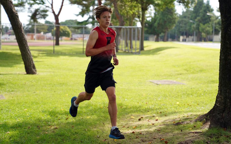 Nile C. Kinnick freshman Maverick Kentz runs a wooded portion of the course during Saturday’s DODEA-Japan cross country meet at Robert D. Edgren, Kentz took first for the boys.