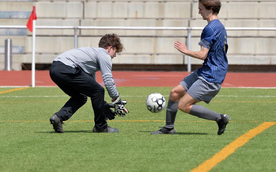Alconbury keeper Nolan Quinn beats Ansbach’s Alexander Pohlman to the ball in a Division III game on opening day of the DODEA-Europe soccer championships in Ramstein, Germany. Ansbach won the game 3-1.