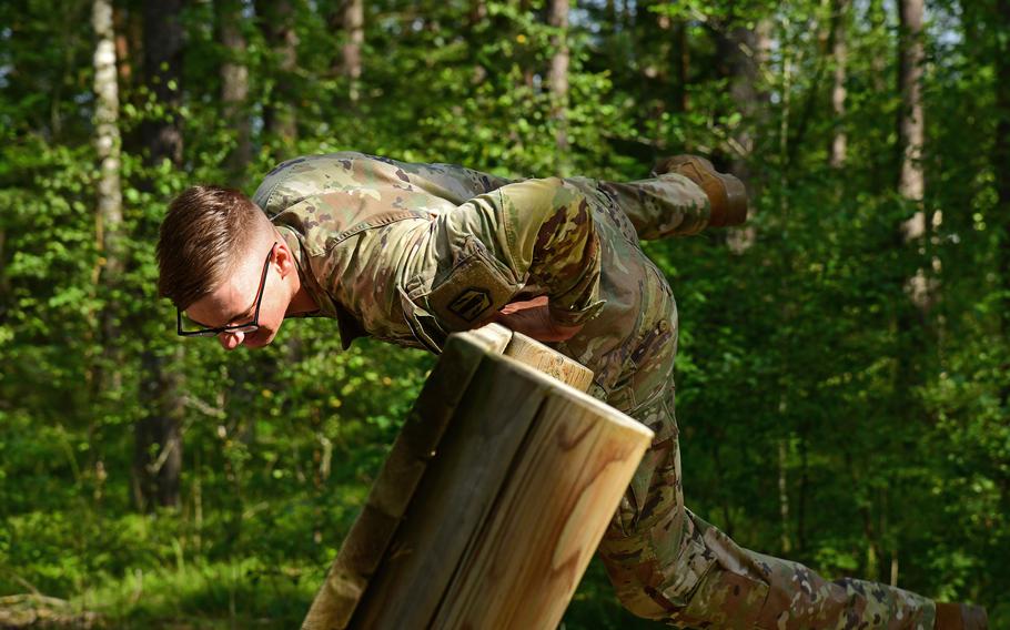 Spc. Shaun Lewis, of the 41st Field Artillery Brigade, jumps over a wall while participating in the obstacle course circuit during the U.S. Army Europe and Africa Best Warrior Competition in Grafenwoehr, Germany, Aug. 9, 2021. Lewis took the title of best soldier in the competition.