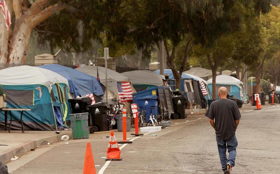 A homeless veteran walks along Veterans Row in West Los Angeles on Oct. 30, 2021.