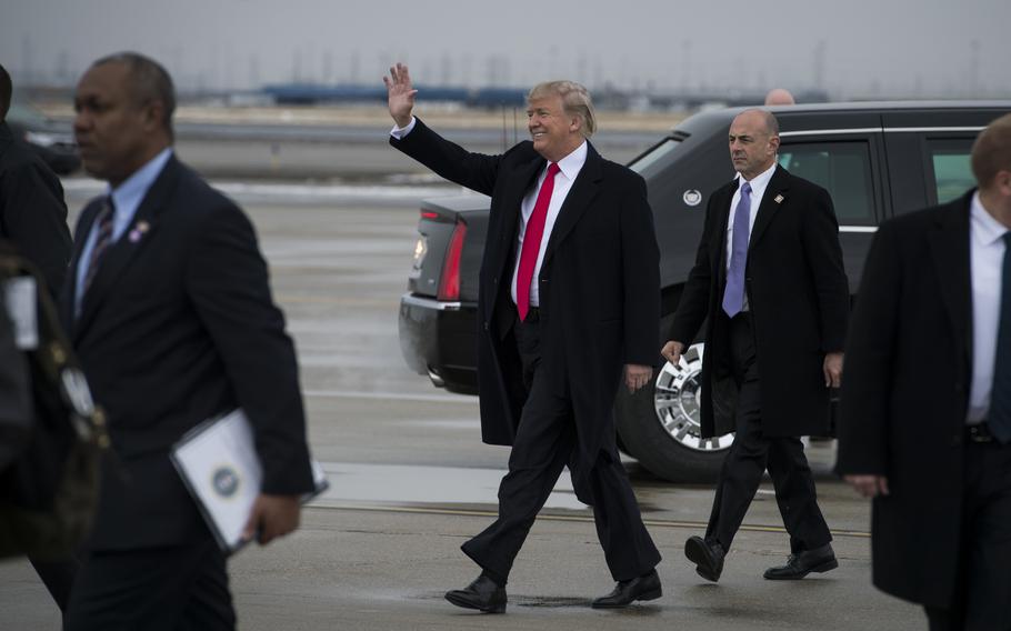 Then-President Donald Trump waves to the crowd in attendance as he arrives at Roland R. Wright Air National Guard Base in Salt Lake City, Utah on December 4, 2017.