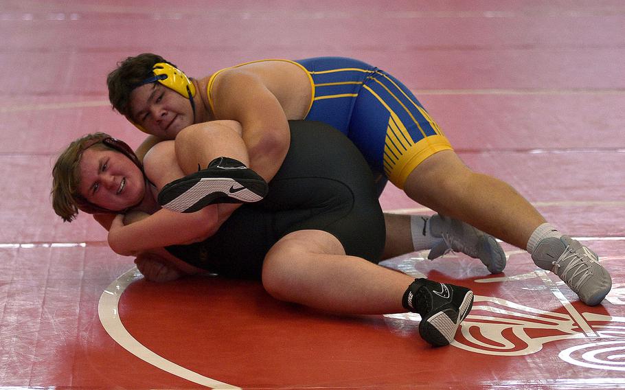 Wiesbaden's Daniel Garin puts Baumholder's Landon Moody in a lock duirng a heavyweight match at a wrestling meet on Dec. 9, 2023, at Kaiserslautern High School in Kaiserslautern, Germany.