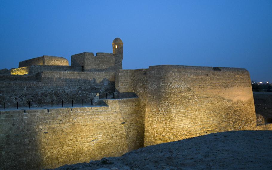 Floodlights illuminate the walls of the archaeological site known as Qal’at al-Bahrain in Manama, Bahrain, at dusk on April 16, 2022.
