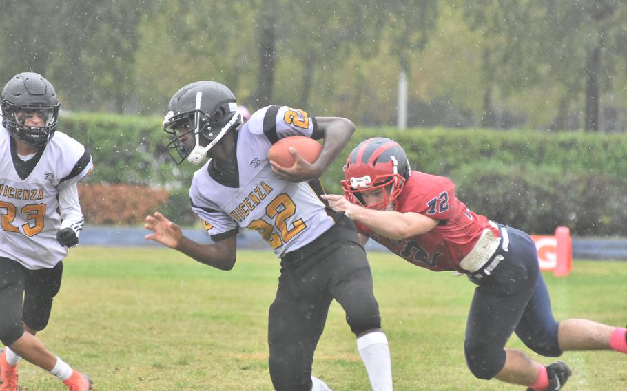 Vicenza's Ezo Lane tries to run with the ball and drag Aviano's Jevan Smith with him in the process in the Saints' 40-0 victory on Saturday, Oct. 22, 2022.