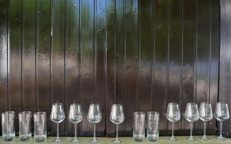 Wine glasses sit on a window sill.