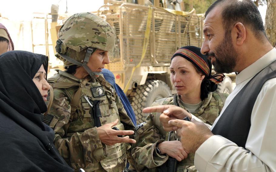 Capt. Johanna Smoke, second from right, speaks with a local official after helping women register to vote in Zabul province, Afghanistan, in 2013. A new study found that thoughts of female soldiers dying in combat does not diminish public support for war.

Kandi Huggins/U.S. Army