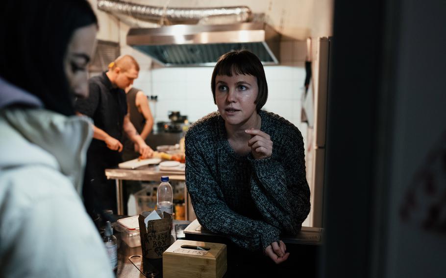 Tanya Raspopova serves a customer at Tuf, a bar established by Russian expats in Yerevan, Armenia, that hosts jazz and rock festivals, on Feb. 1.