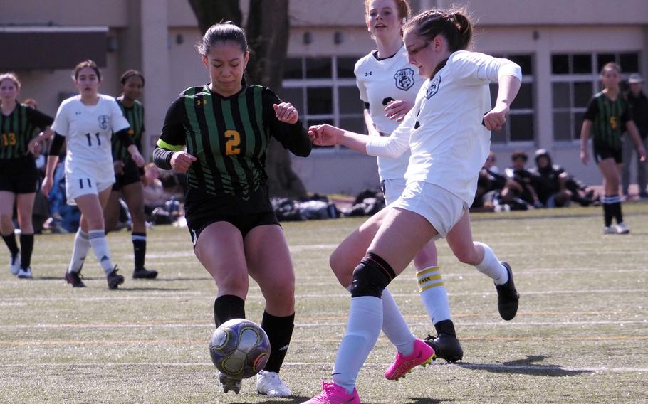 Zama’s Juliet Bitor and Robert D. Edgren’s Aliyah Torres scuffle for the ball in front of Zama’s Avery Pilsch during Saturday’s DODEA-Japan girls soccer match. The Trojans won 2-1 to sweep the weekend series.