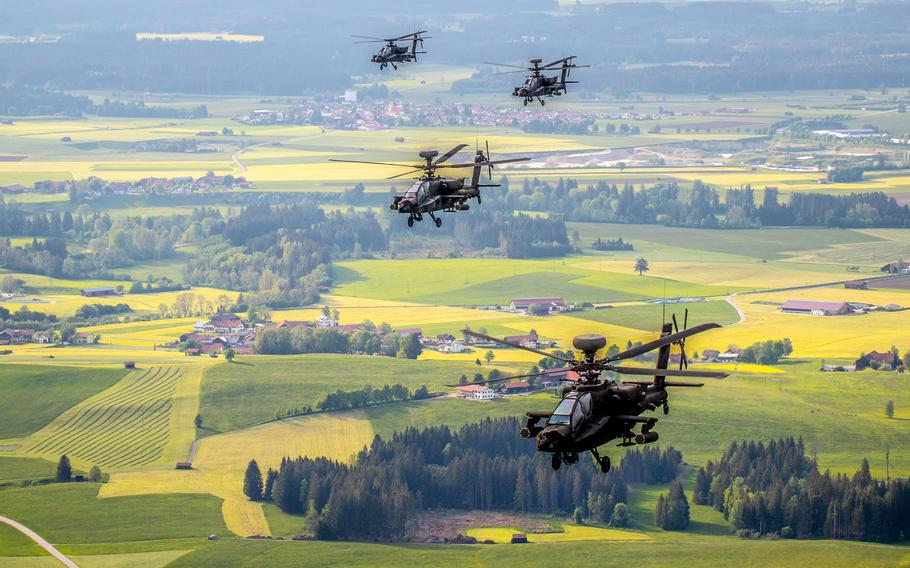 A formation of AH-64 Apache attack helicopters flies over Germany in 2020.