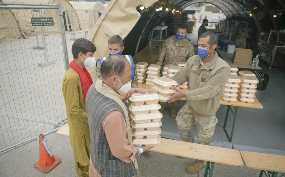 U.S. airmen hand out meals to evacuees from Afghanistan as part of Operation Allies Refuge at Ramstein Air Base, Germany, on Aug. 27, 2021. Evacuees were provided temporary lodging, food, water and medical services while preparing for onward movements to other transient locations during Operation Allies Refuge. 
