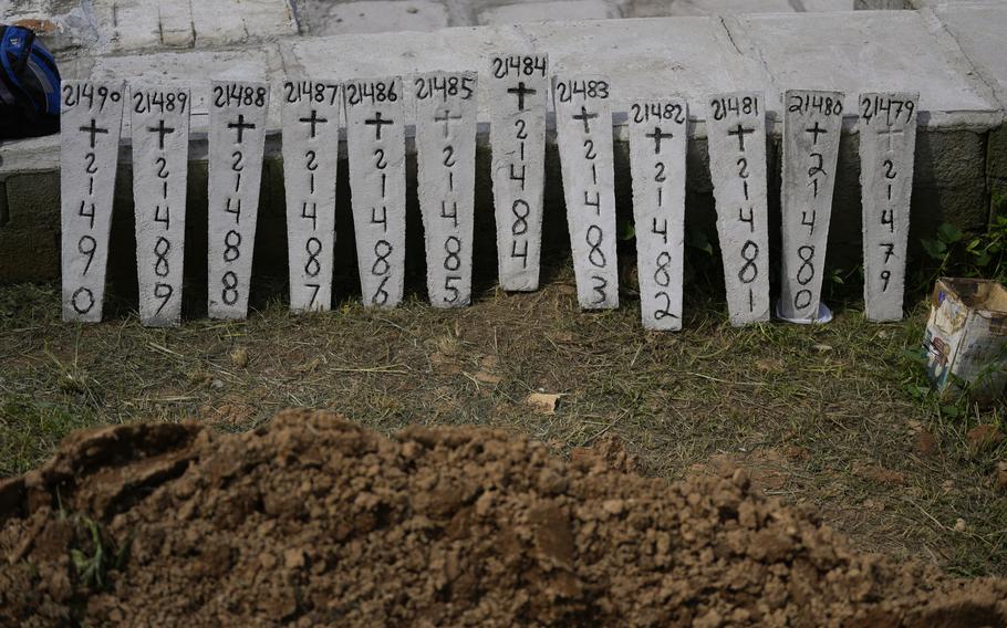 Identification numbers are lined up at the Municipal Cemetery for the burials of mudslide victims in Petropolis, Brazil, Thursday, Feb. 17, 2022. 