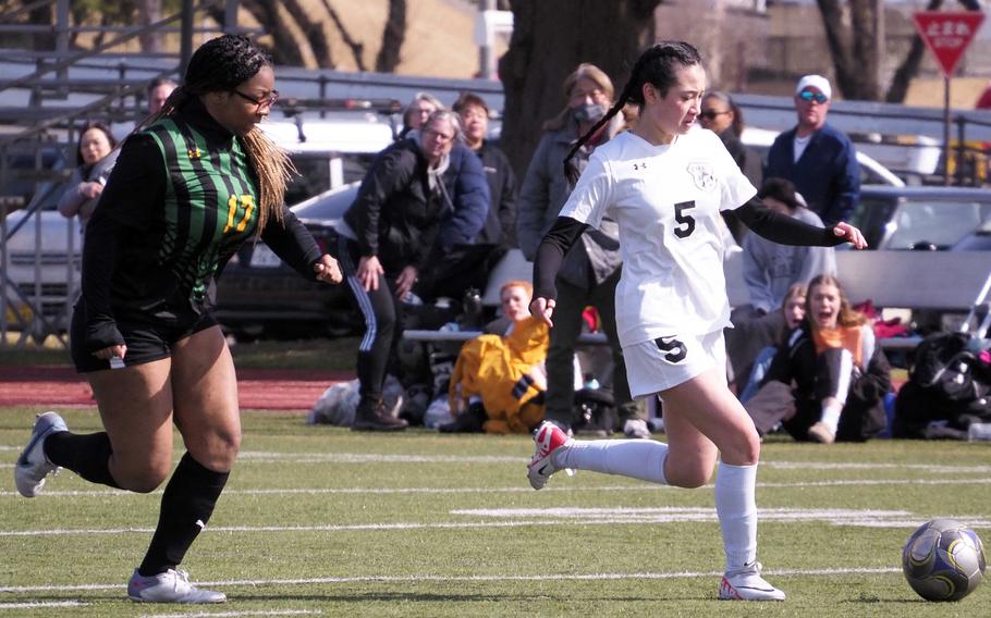 Zama’s Sara Zambrano dribbles upfield against Robert D. Edgren’s Jordan Watson during Saturday’s DODEA-Japan girls soccer match. The Trojans won 2-1 to sweep the weekend series.