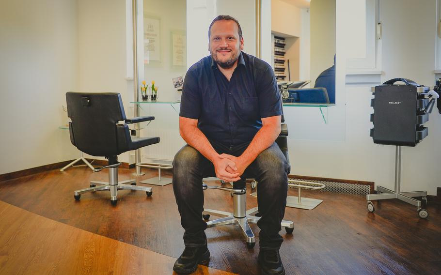 Master barber Ulrich Jung in his shop in the historic city center of Baumholder, Germany, July 12, 2022. Jung is also a junior deputy major and said U.S. presence has always been an important aspect of life in the small German town.