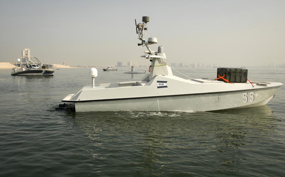 Unmanned ships with green boxes containing aerial drones prowled the waters near Naval Support Activity Bahrain in December 2022, as part of an exercise that was the first test of 10 systems by the U.S. 5th Fleet. 