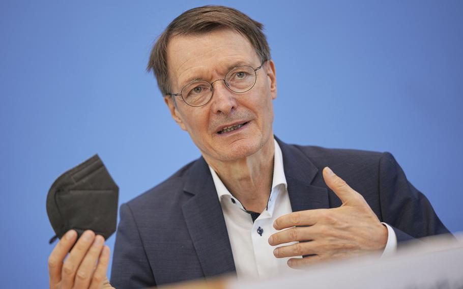 Karl Lauterbach, federal minister of Health, shows an FFP2 mask during a news conference in Berlin, Friday, June 17, 2022.